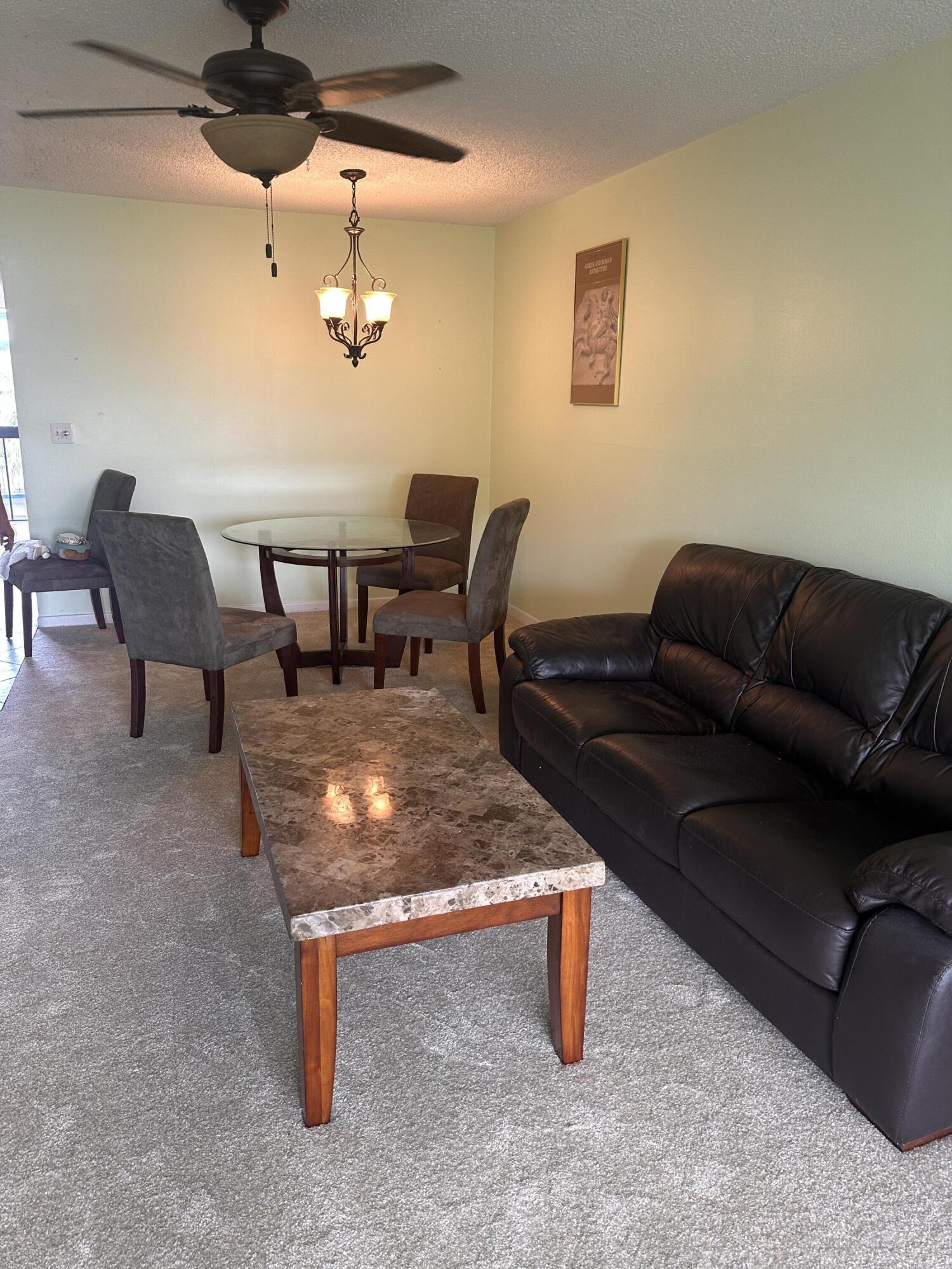 3090 Holiday Springs Boulevard, Unit 310 Margate, FL 33063 - Photo 16 of 26 a living room with furniture