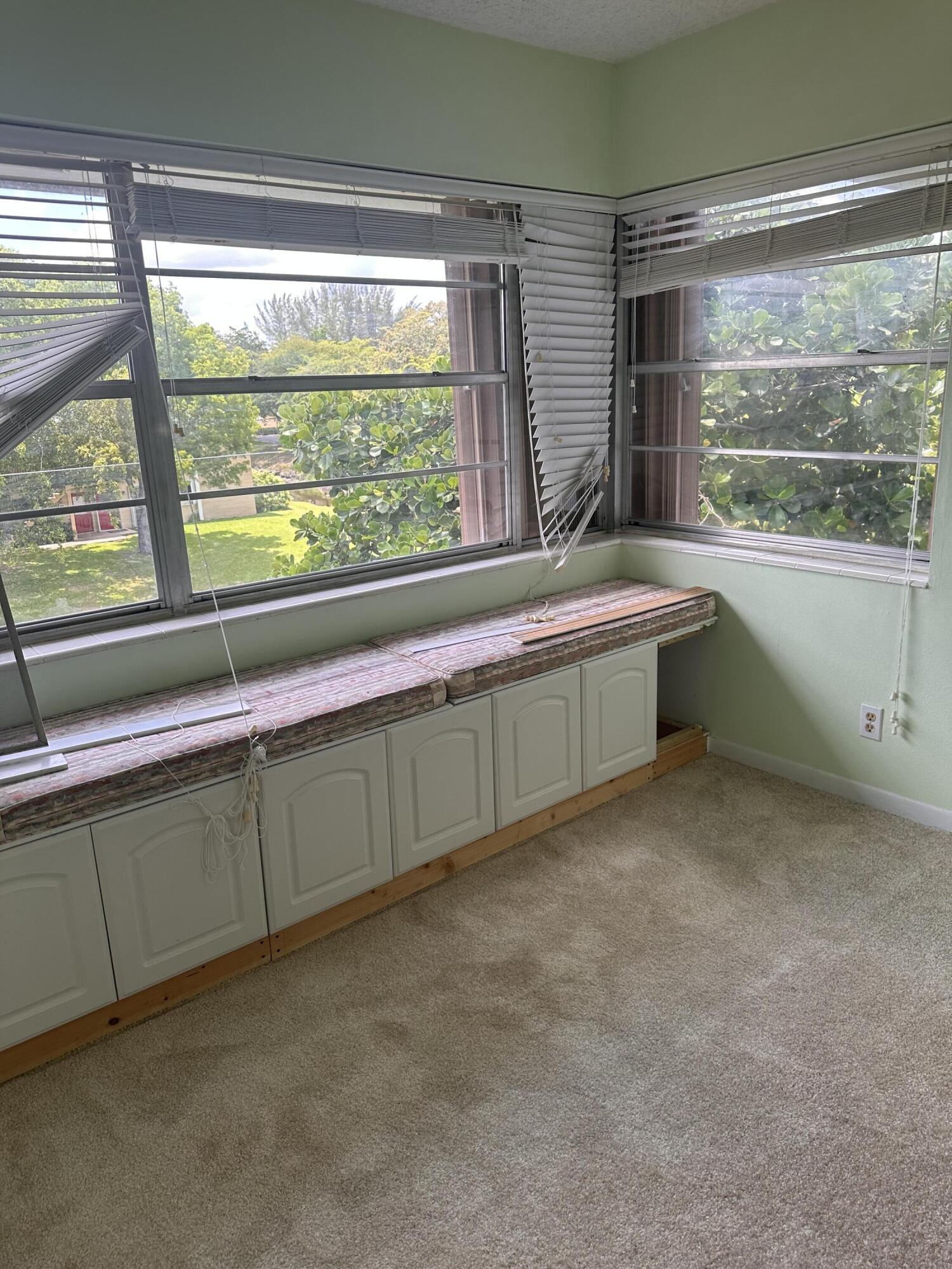 3090 Holiday Springs Boulevard, Unit 310 Margate, FL 33063 - Photo 17 of 26 a kitchen with a large window sink and cabinets