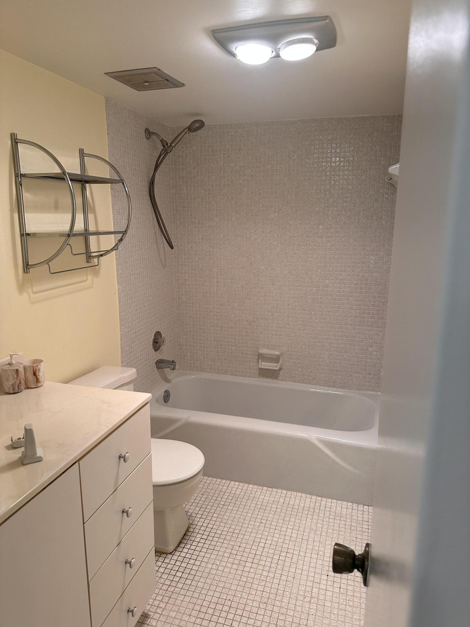3090 Holiday Springs Boulevard, Unit 310 Margate, FL 33063 - Photo 20 of 26 a bathroom with a granite countertop sink a toilet and shower