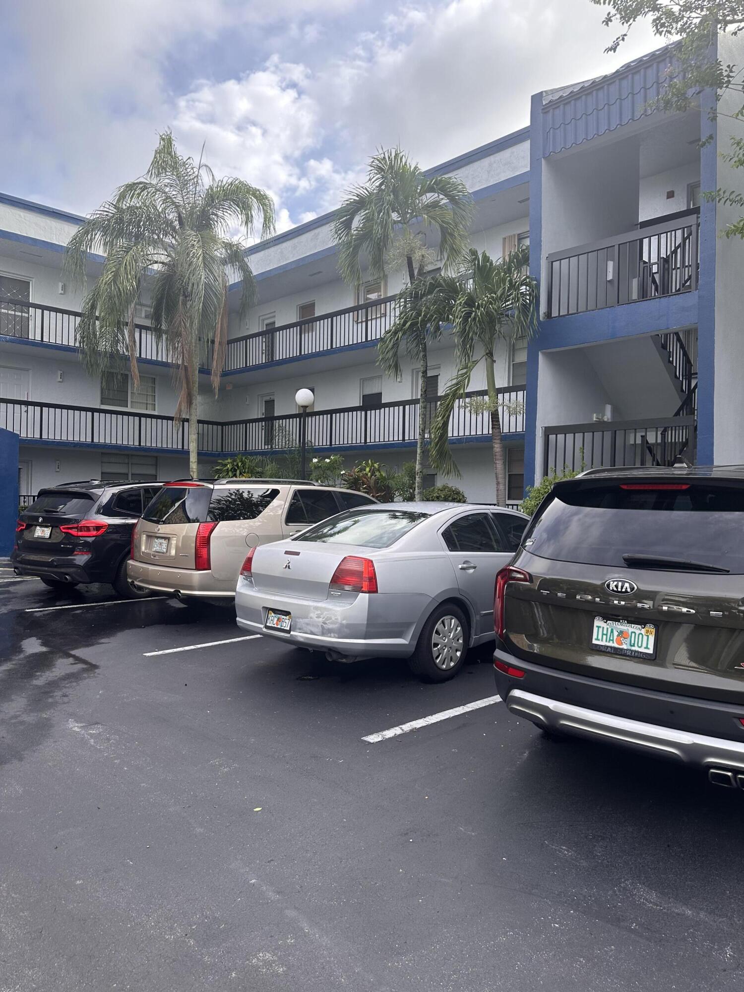 3090 Holiday Springs Boulevard, Unit 310 Margate, FL 33063 - Photo 2 of 26 a view of a cars park in front of a building