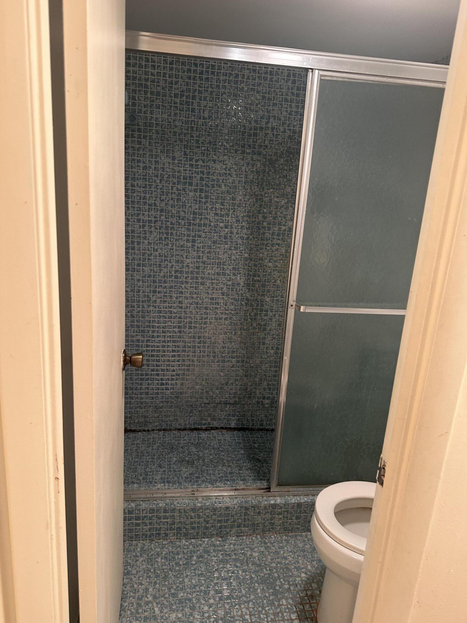 3090 Holiday Springs Boulevard, Unit 310 Margate, FL 33063 - Photo 22 of 26 a bathroom with a shower and a toilet