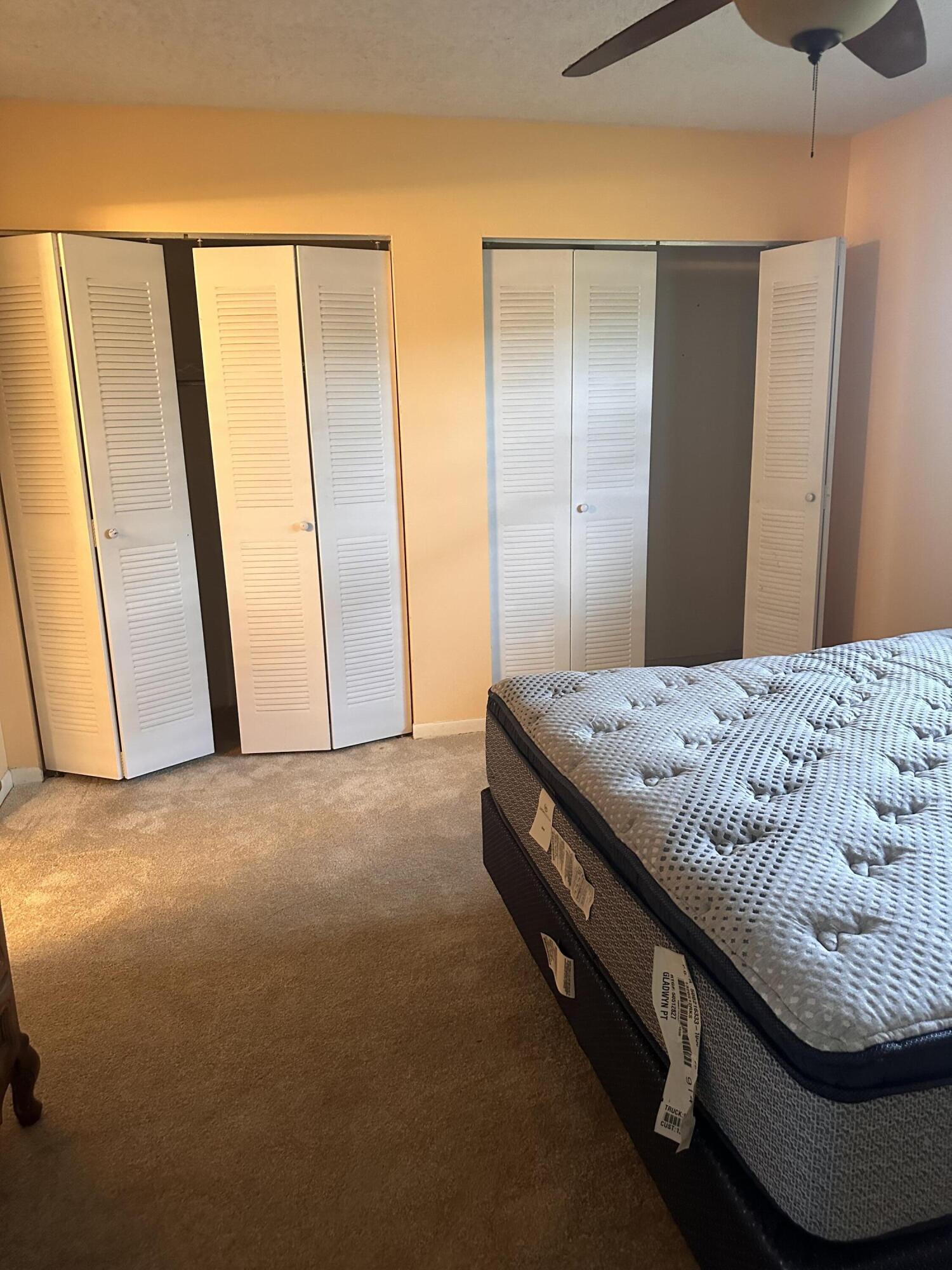 3090 Holiday Springs Boulevard, Unit 310 Margate, FL 33063 - Photo 23 of 26 a bedroom with a bed and a mirror