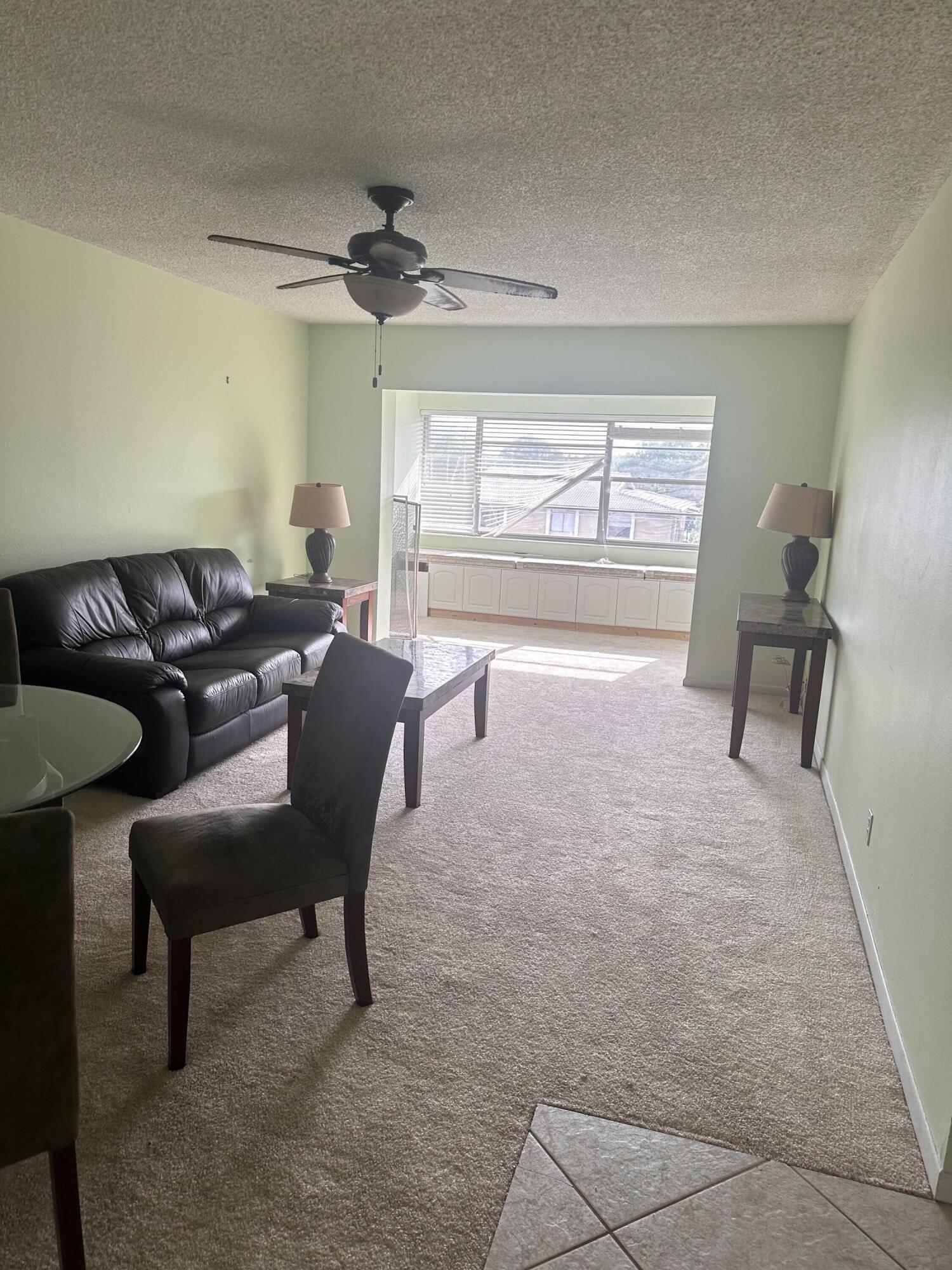 3090 Holiday Springs Boulevard, Unit 310 Margate, FL 33063 - Photo 24 of 26 a living room with furniture and a window