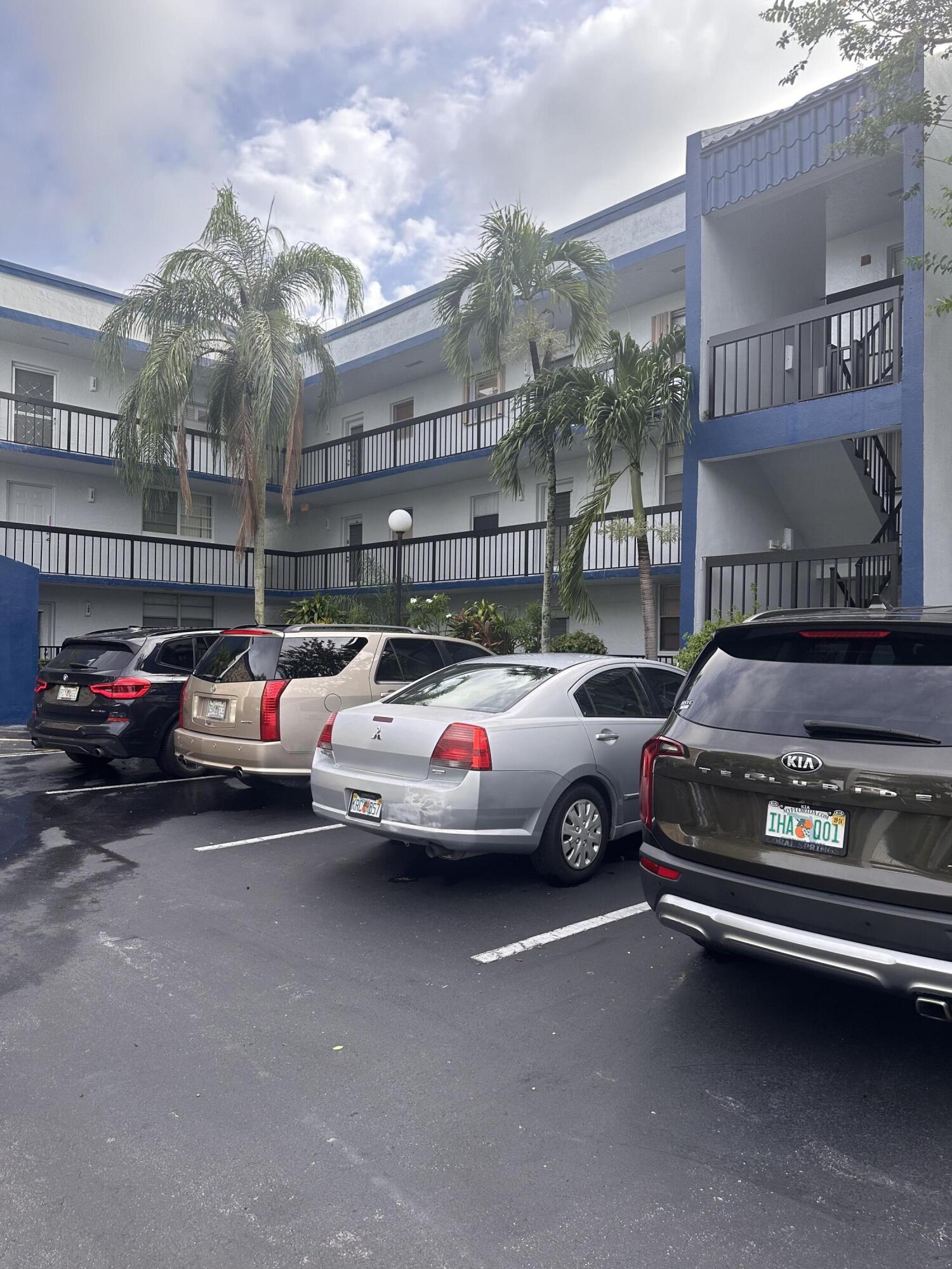 3090 Holiday Springs Boulevard, Unit 310 Margate, FL 33063 - Photo 3 of 26 a cars parked in front of a building