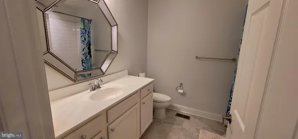 a bathroom with a sink toilet and mirror