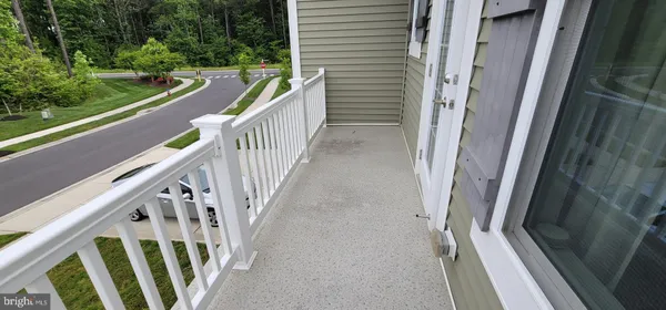 a view of a balcony with wooden floor