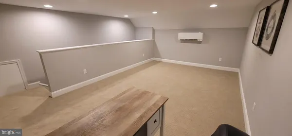 an empty room with wooden floor and entrance