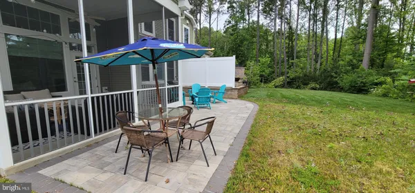 a view of a patio with a table and chairs under an umbrella