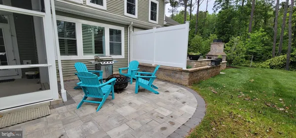 a view of a house with backyard sitting area and garden