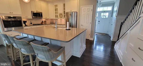 a dining room with furniture and wooden floor