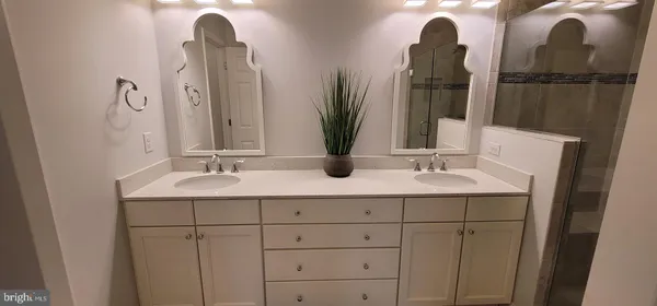 a bathroom with a double vanity sink and a mirror