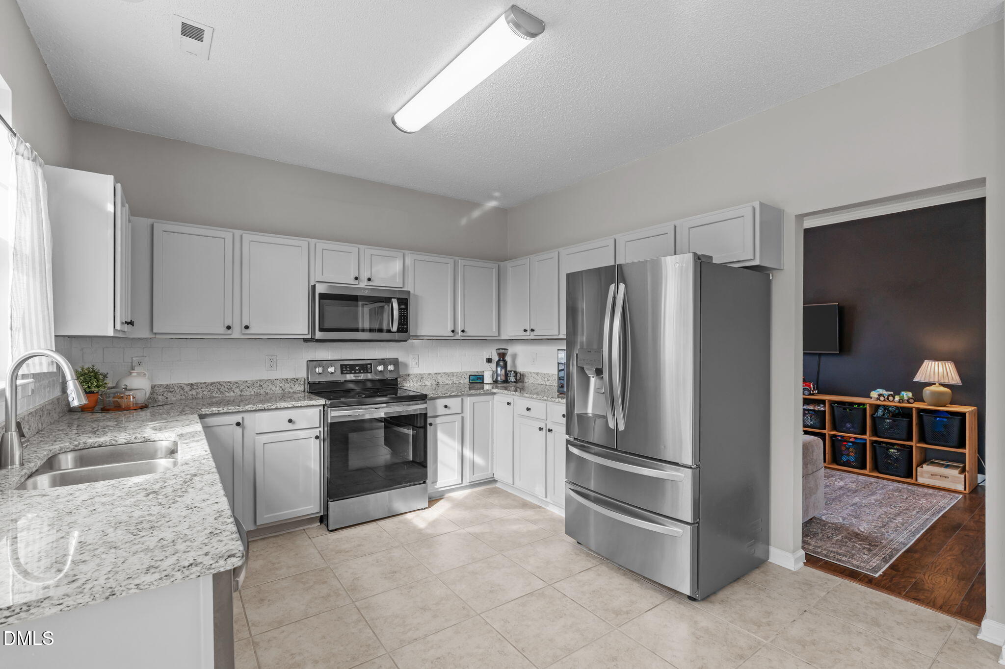 400 New Timber Path Apex, NC 27502 - Photo 12 of 34 a kitchen with stainless steel appliances granite countertop a refrigerator stove and sink