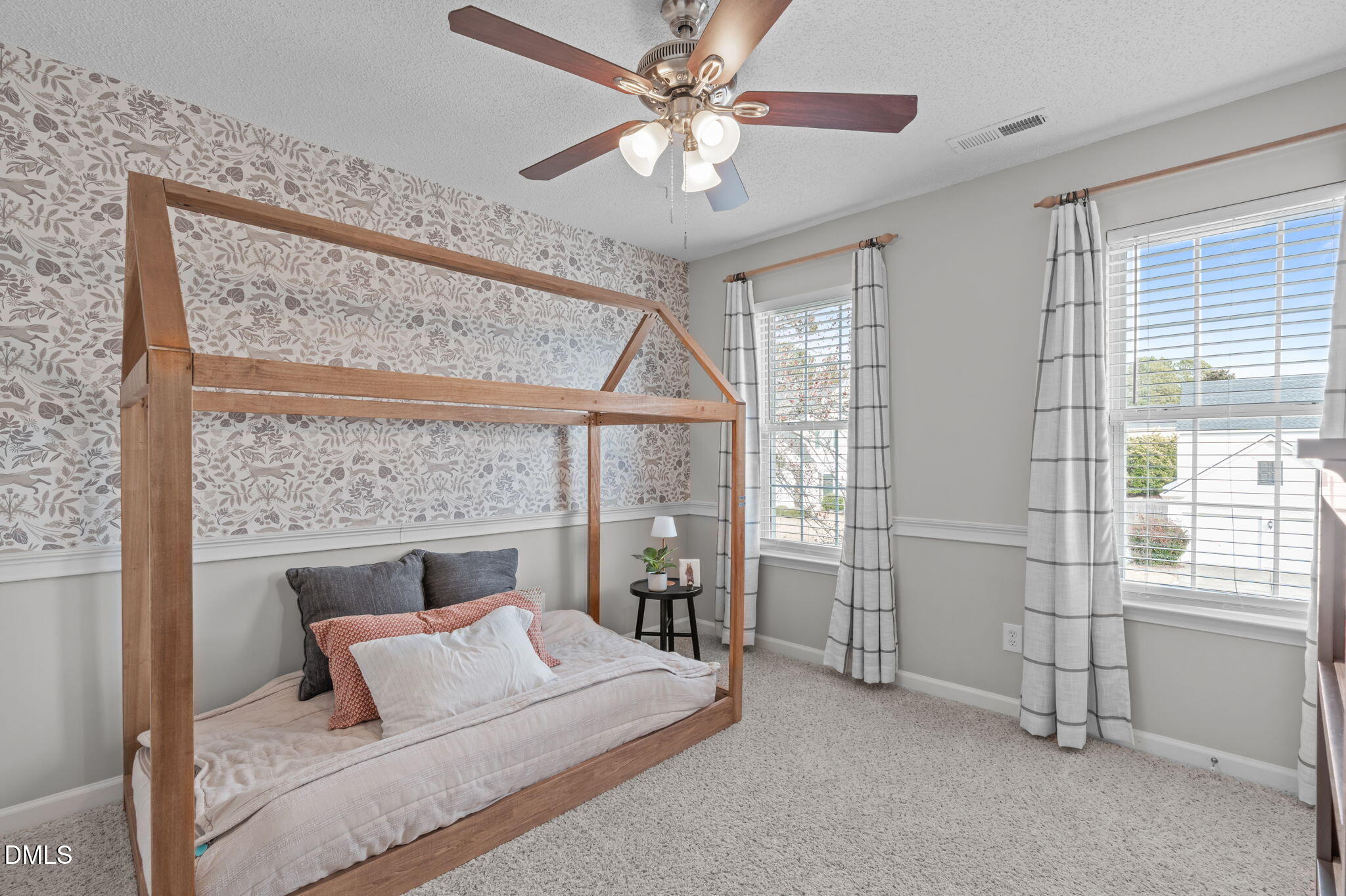 400 New Timber Path Apex, NC 27502 - Photo 22 of 34 a bedroom with a large bed and a chandelier fan