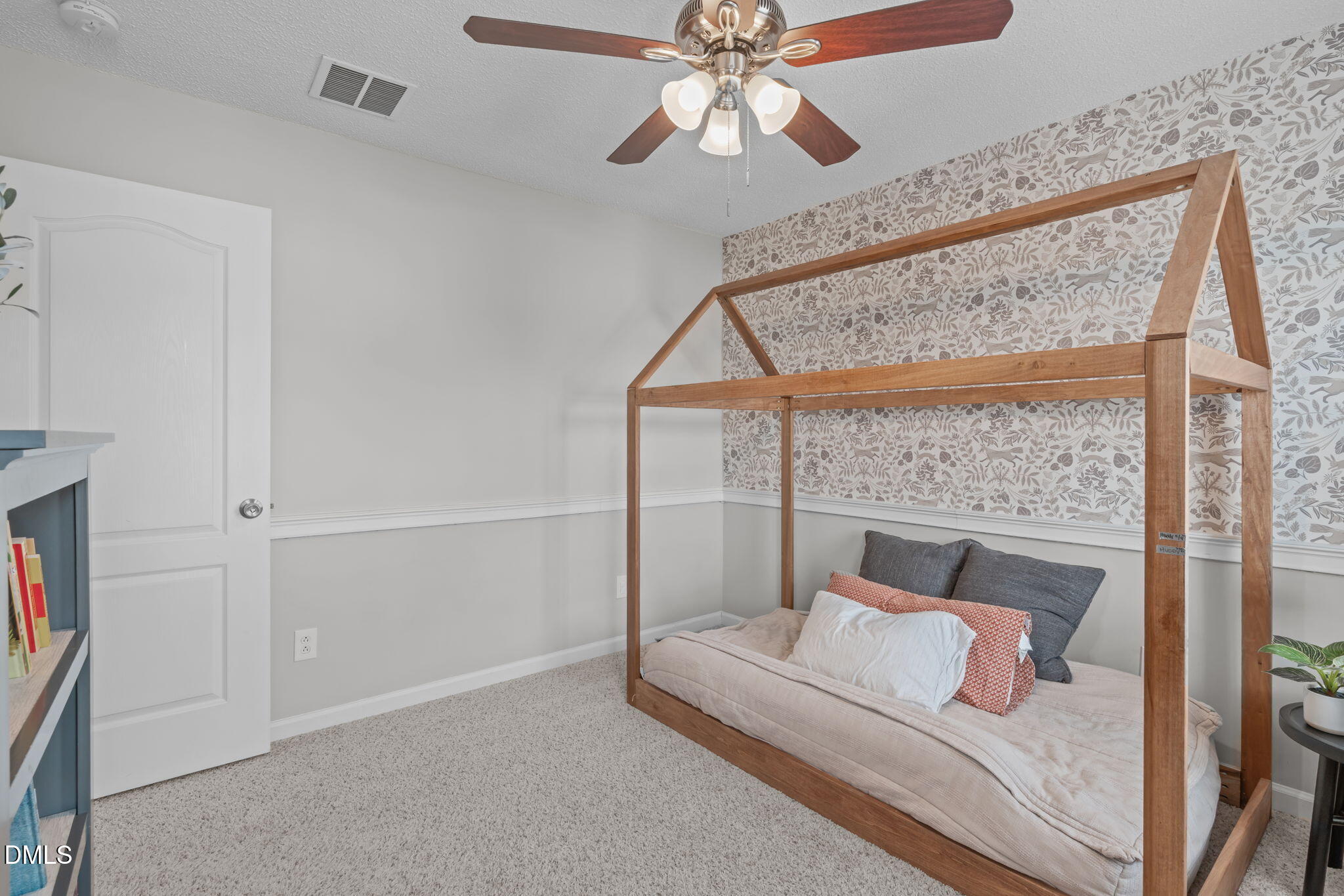 400 New Timber Path Apex, NC 27502 - Photo 23 of 34 a bedroom with a bed and a chandelier