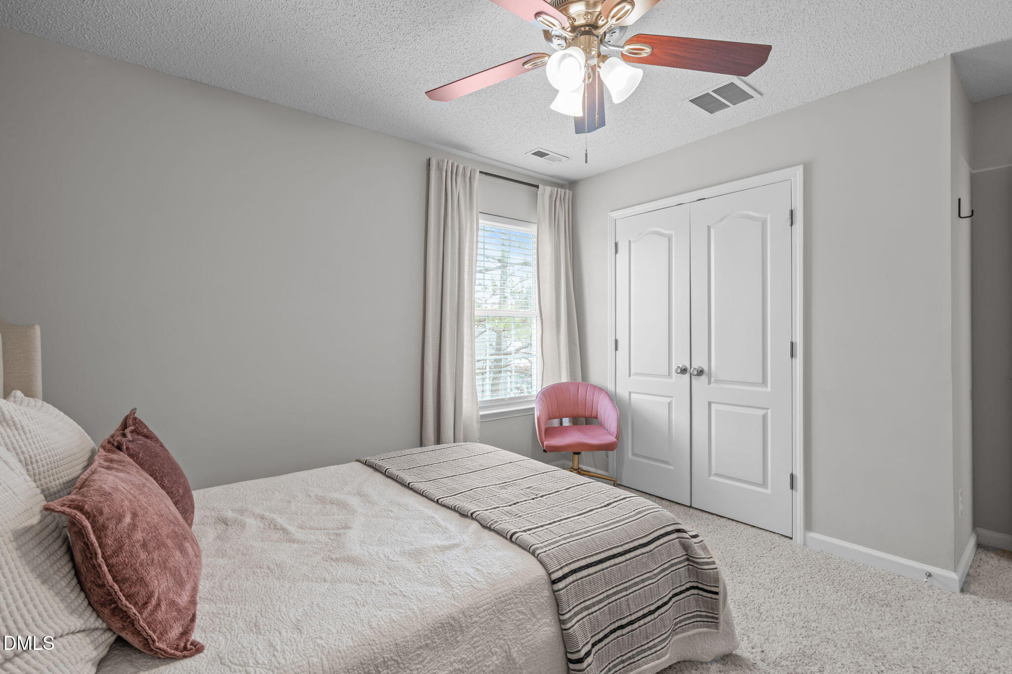 400 New Timber Path Apex, NC 27502 - Photo 25 of 34 a bedroom with a bed and a chandelier