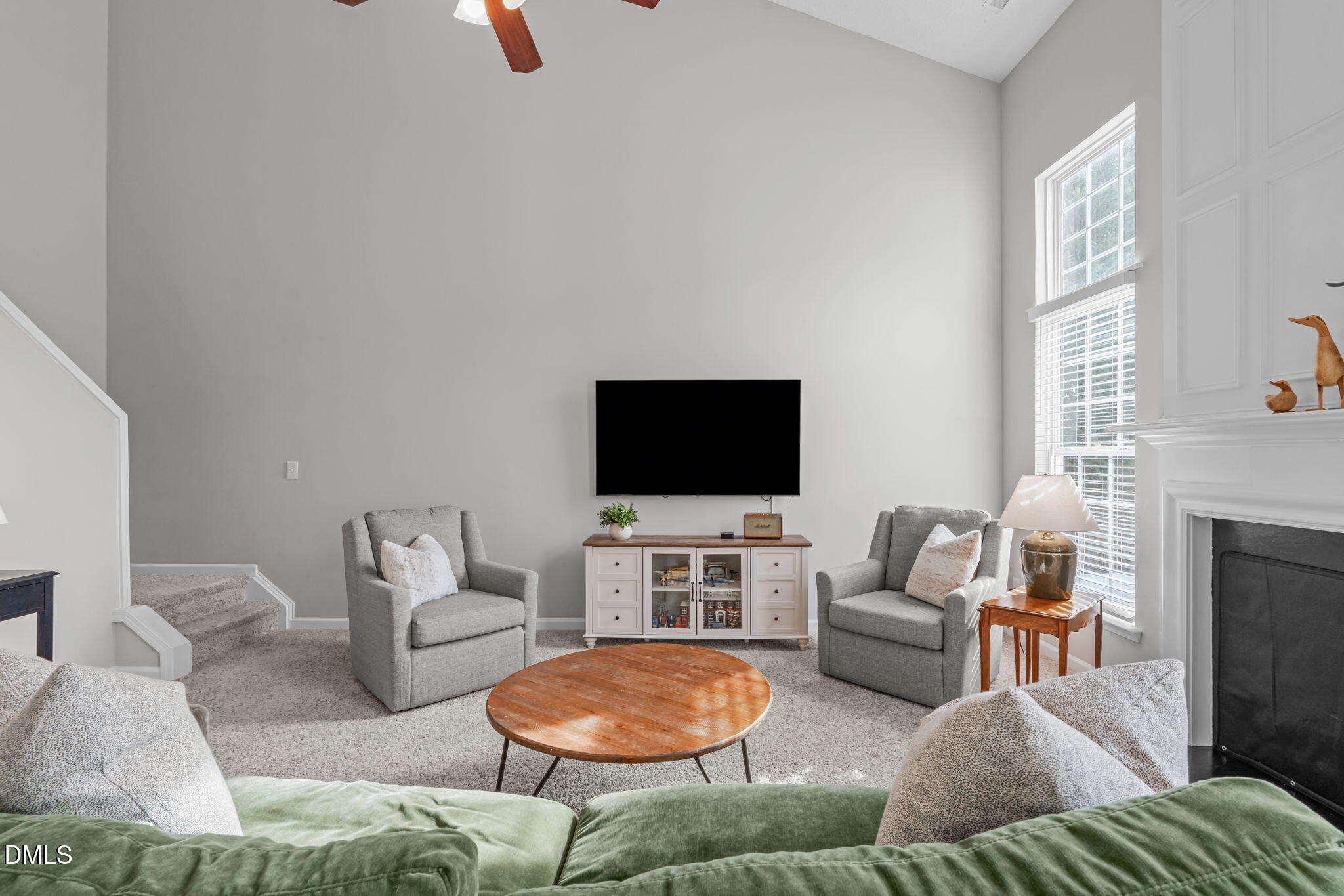 400 New Timber Path Apex, NC 27502 - Photo 5 of 34 a living room with furniture a flat screen tv and a fireplace