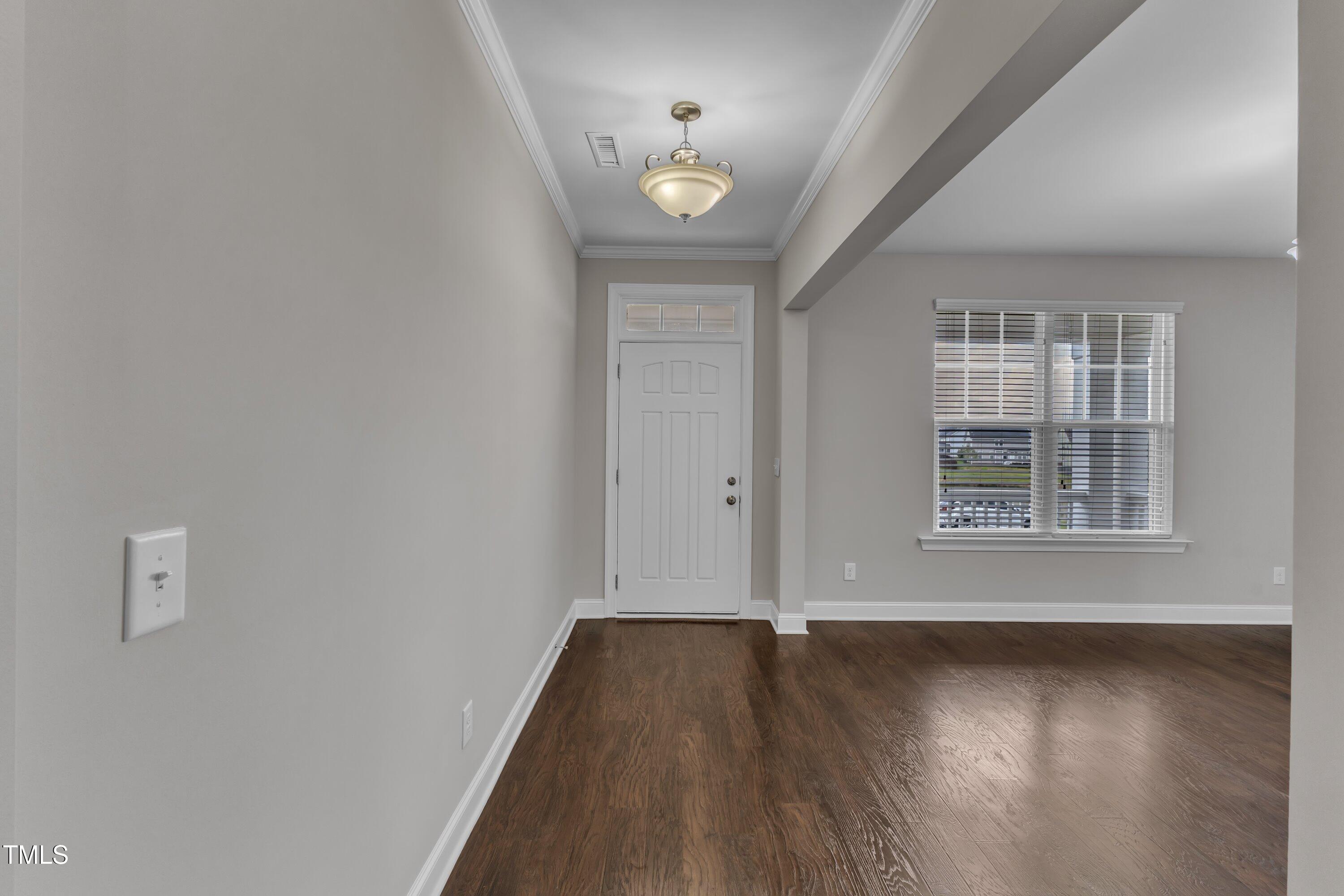 4252 Rockdell Hall Street Raleigh, NC 27616 - Photo 16 of 64 an empty room with wooden floor and windows