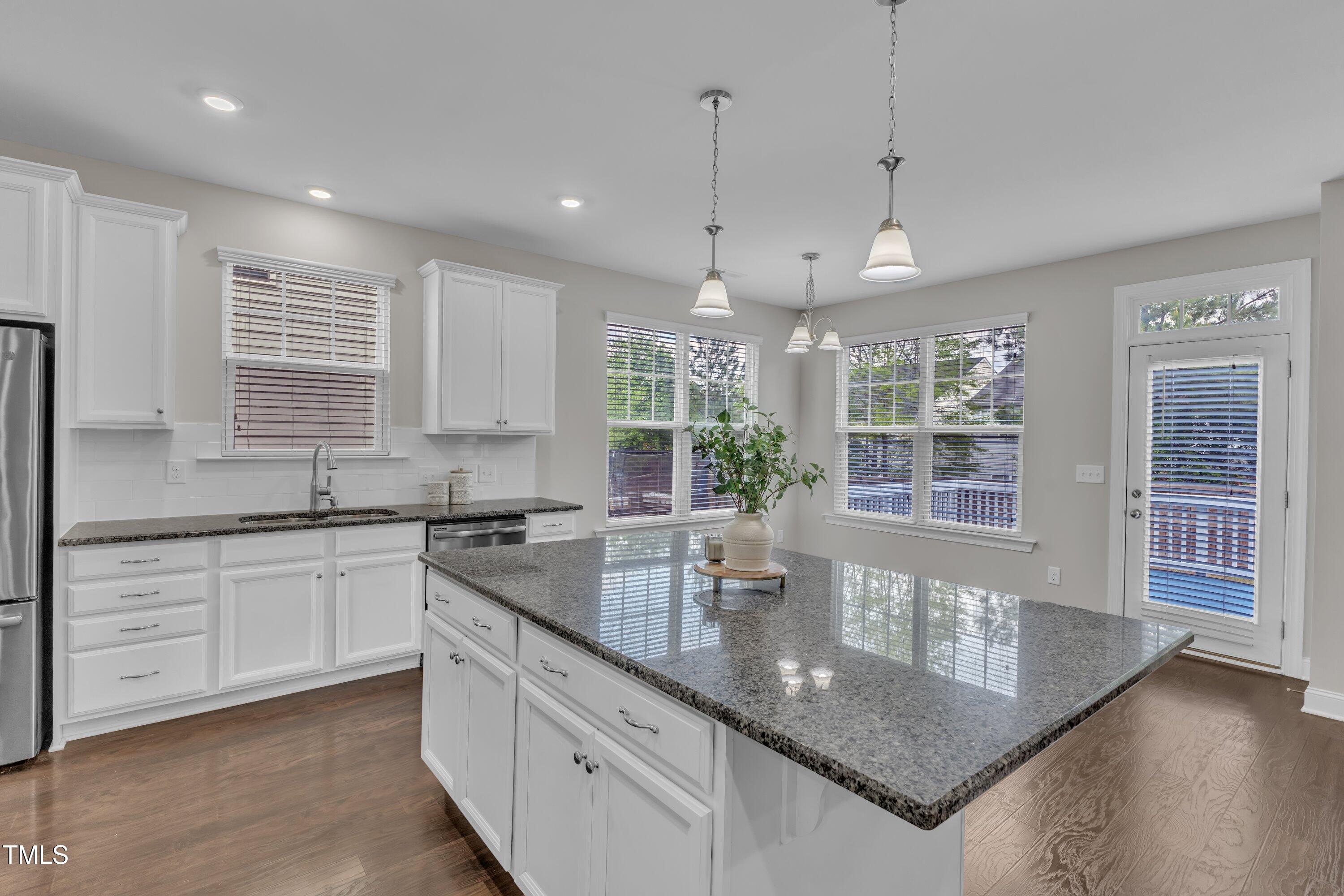 4252 Rockdell Hall Street Raleigh, NC 27616 - Photo 22 of 64 a kitchen with stainless steel appliances granite countertop a sink a stove and a granite counter tops