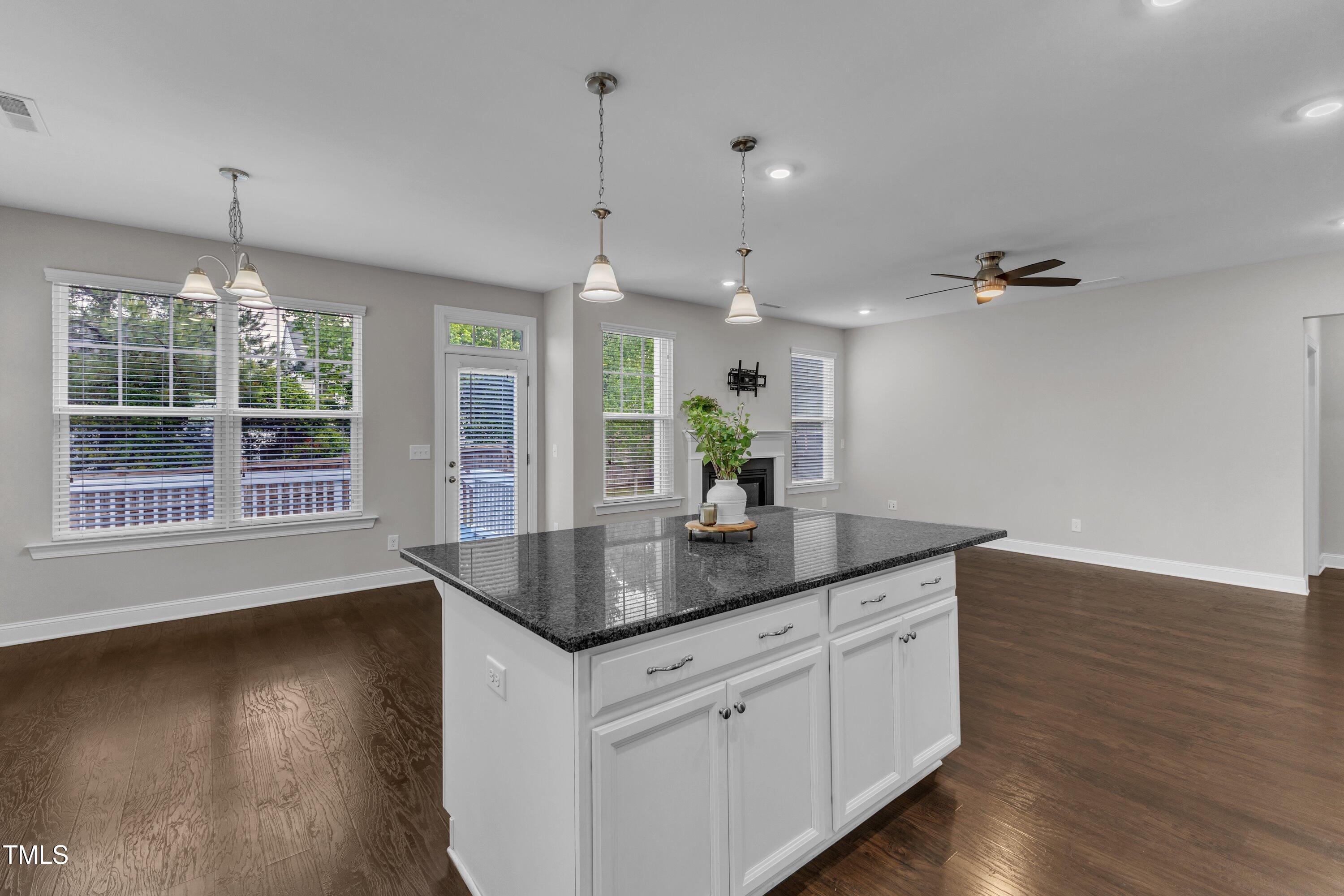 4252 Rockdell Hall Street Raleigh, NC 27616 - Photo 24 of 64 a kitchen with stainless steel appliances granite countertop a sink a window and wooden floor