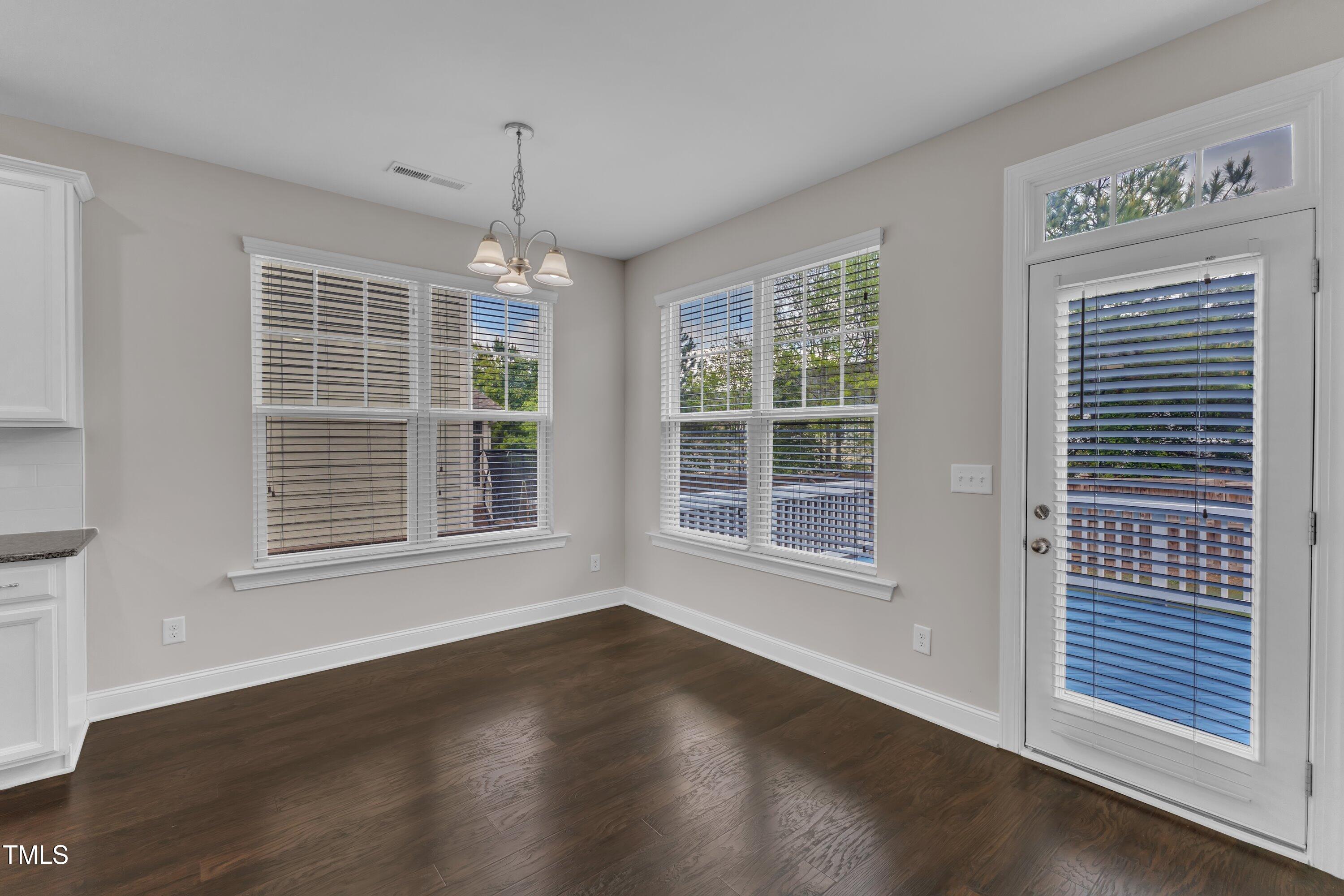 4252 Rockdell Hall Street Raleigh, NC 27616 - Photo 26 of 64 an empty room with wooden floor and windows