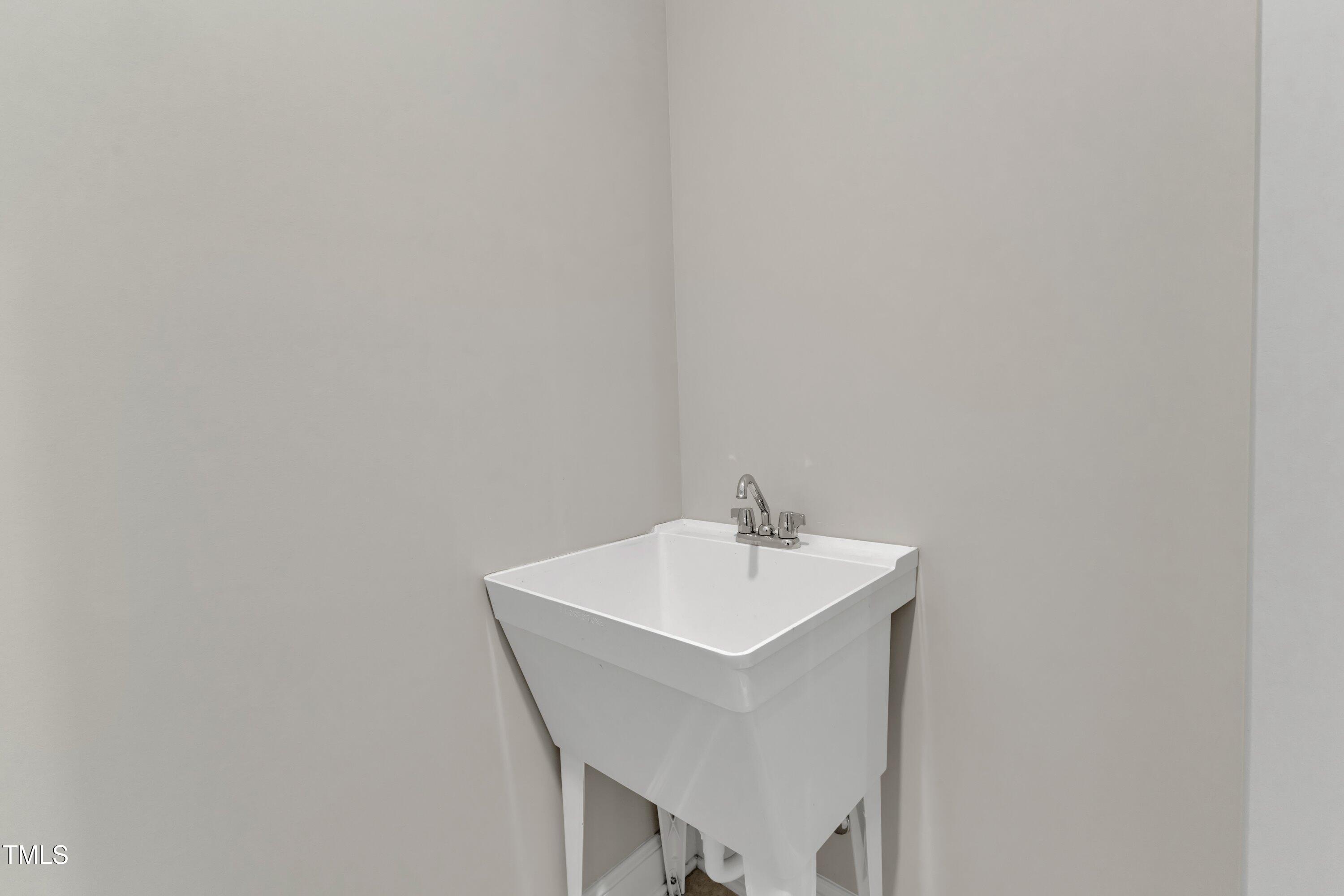 4252 Rockdell Hall Street Raleigh, NC 27616 - Photo 35 of 64 a white bathroom with sink and mirror