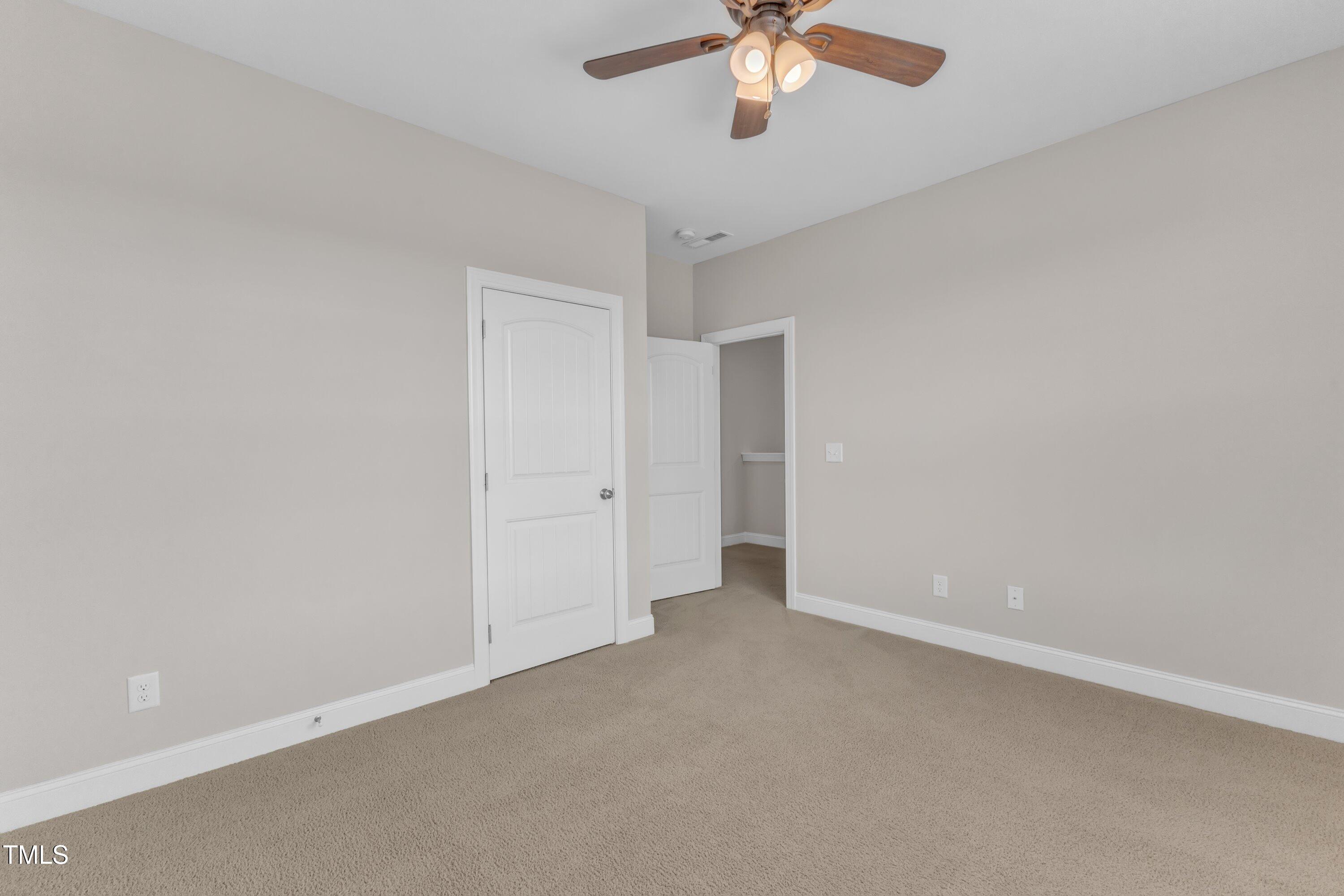 4252 Rockdell Hall Street Raleigh, NC 27616 - Photo 44 of 64 an empty room with a empty space and a ceiling fan