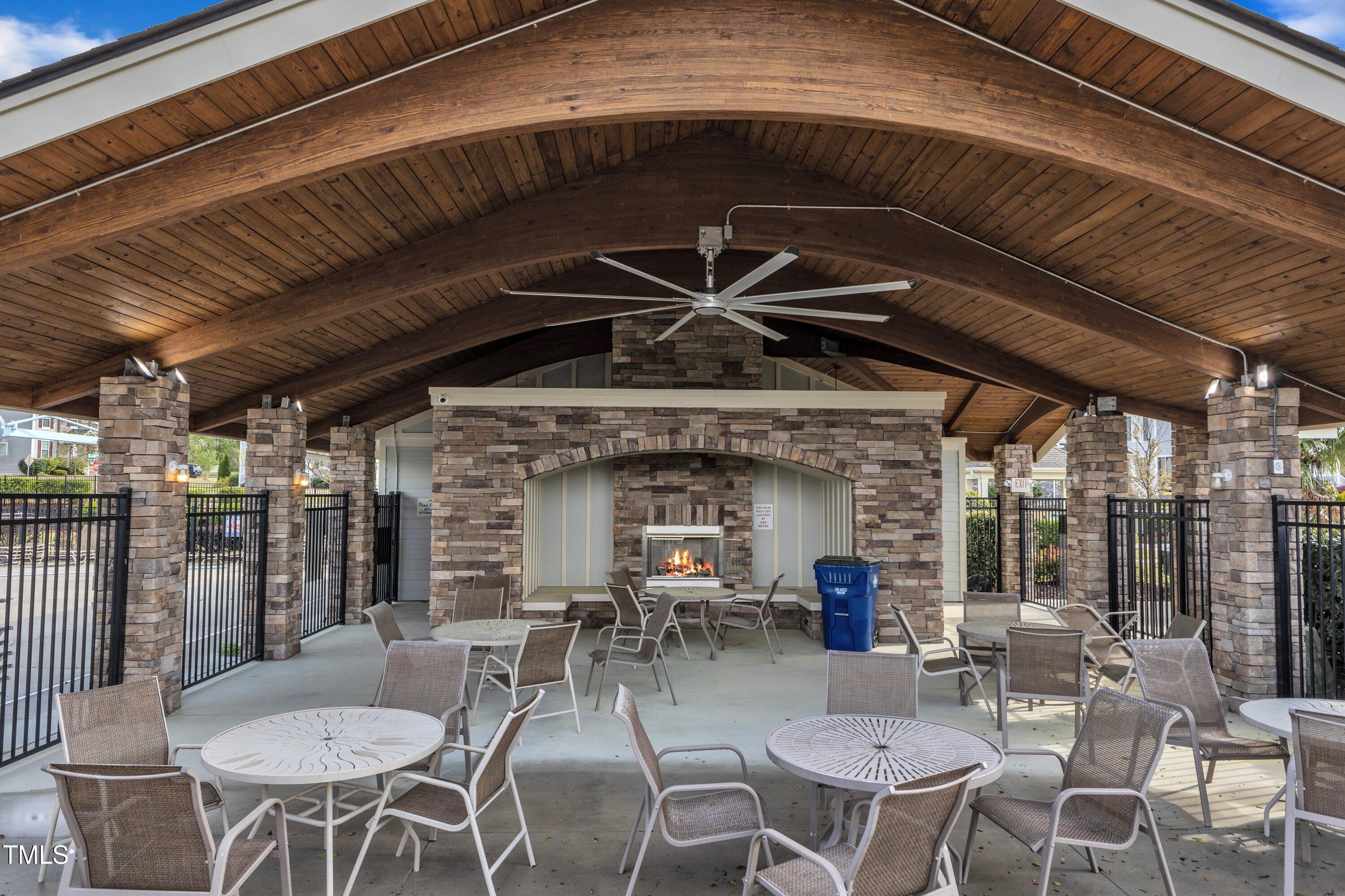 4252 Rockdell Hall Street Raleigh, NC 27616 - Photo 59 of 64 a view of a patio with table and chairs potted plants and floor to ceiling window