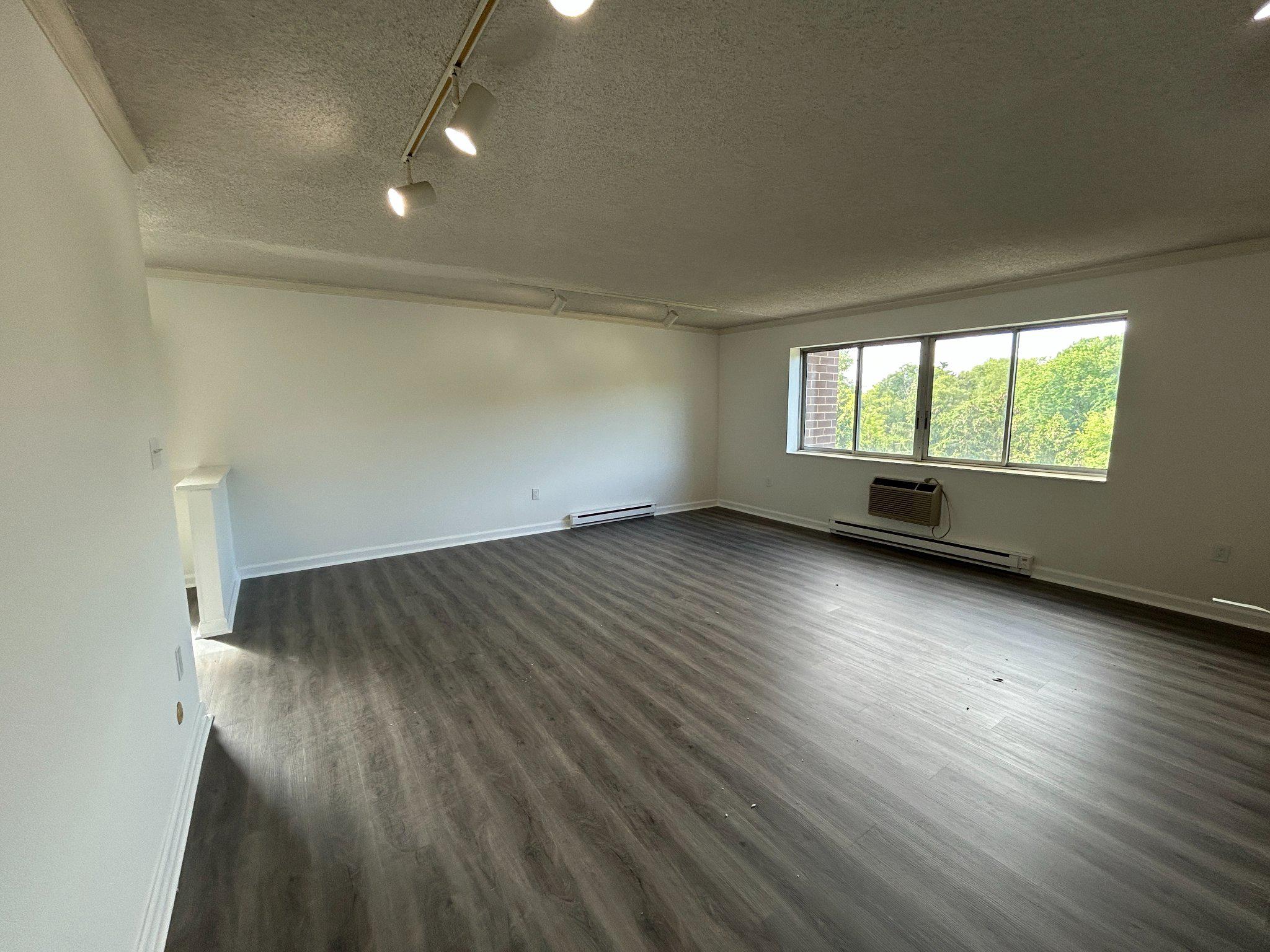 860 Lower Ferry Road, Unit 6M Ewing, NJ 08628 - Photo 9 of 16 an empty room with wooden floor and windows