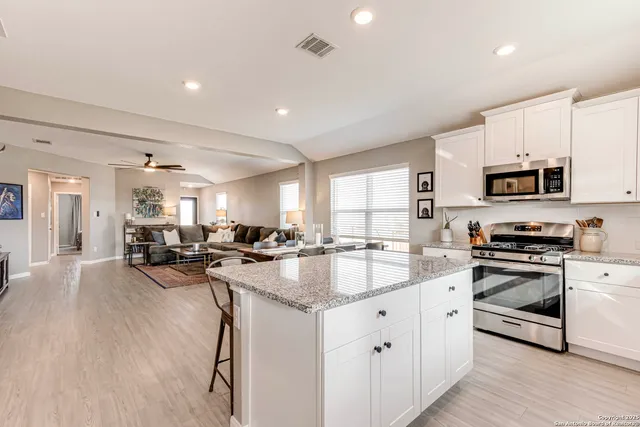 a kitchen with sink stove and cabinets