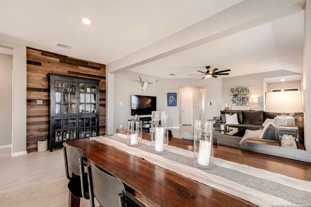 a living room with furniture a flat screen tv and a large window