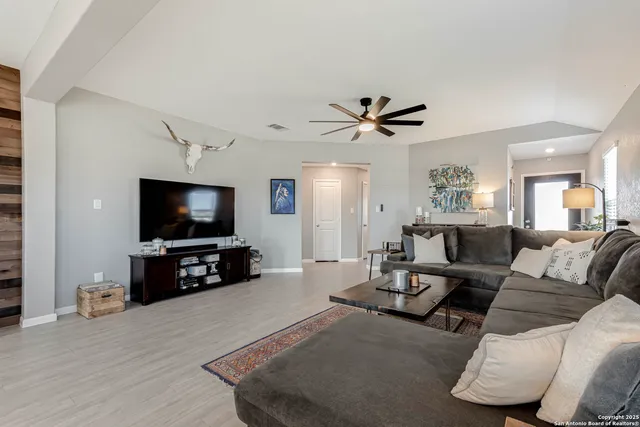 a living room with furniture and a flat screen tv