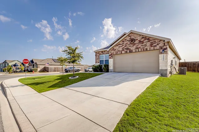 a front view of a house with a yard and a garage