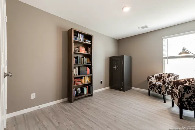 an empty room with bookshelf and a window
