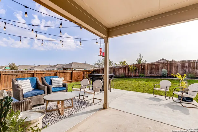 a view of an chairs and tables in the backyard