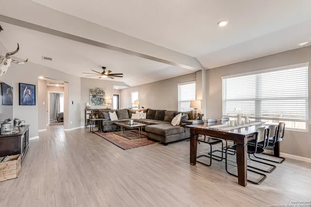 a living room with furniture and wooden floor