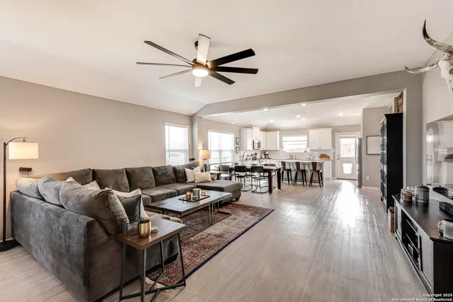 a living room with furniture and wooden floor