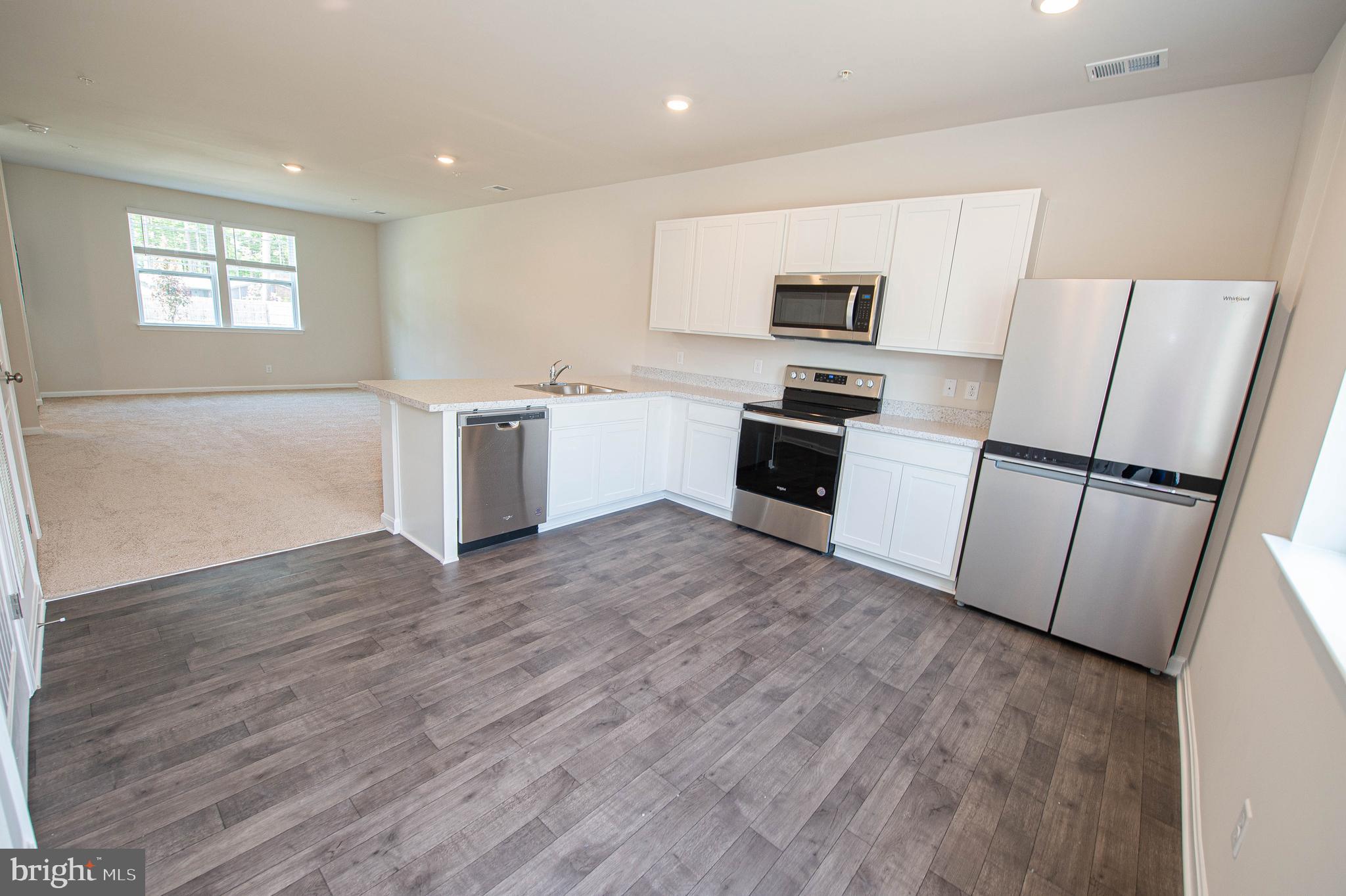130 Willowtree Lane Fruitland, MD 21826 - Photo 24 of 74 a kitchen with granite countertop a refrigerator and a stove top oven