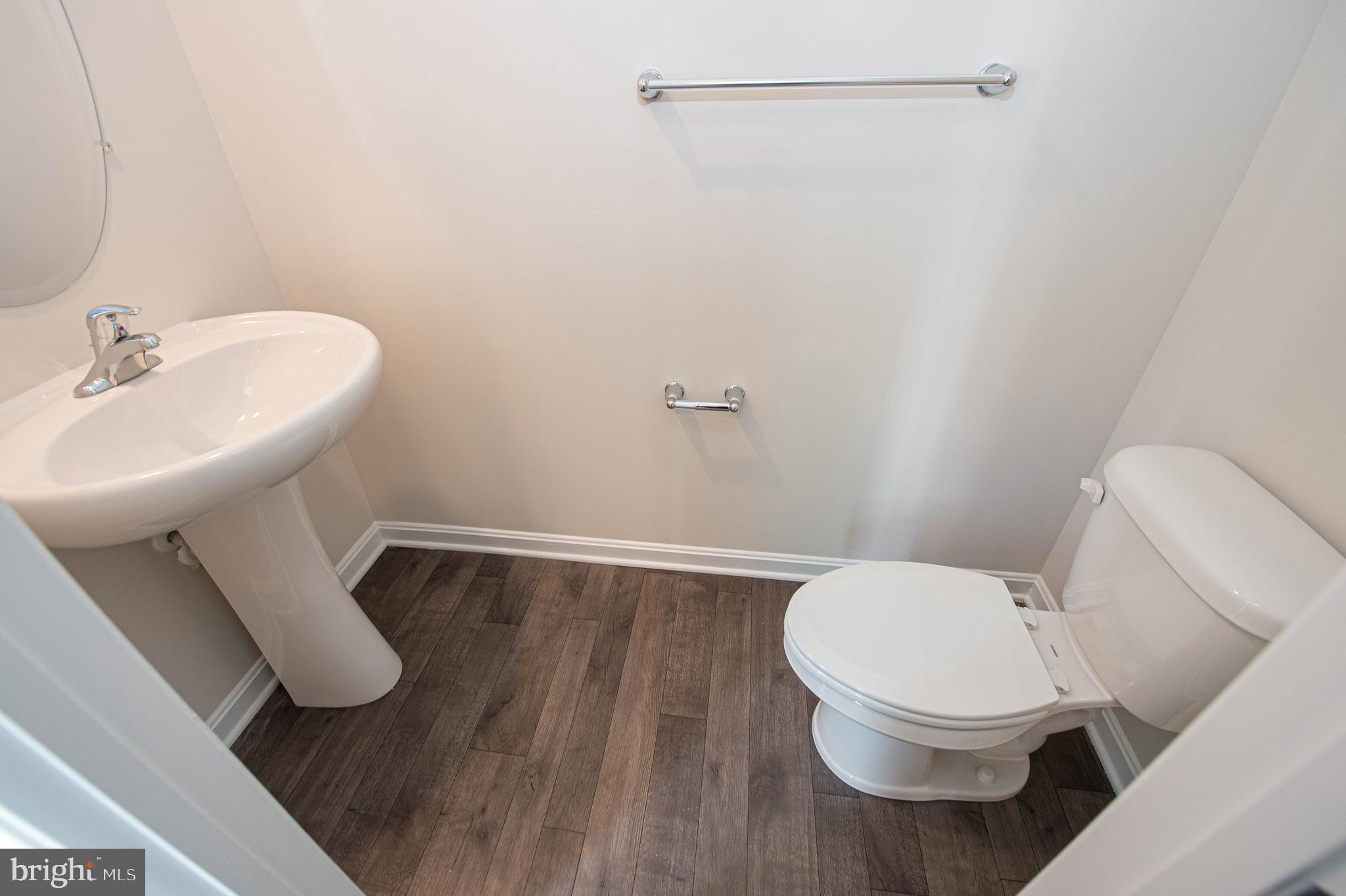 130 Willowtree Lane Fruitland, MD 21826 - Photo 30 of 74 a white toilet sitting next to a bathroom sink