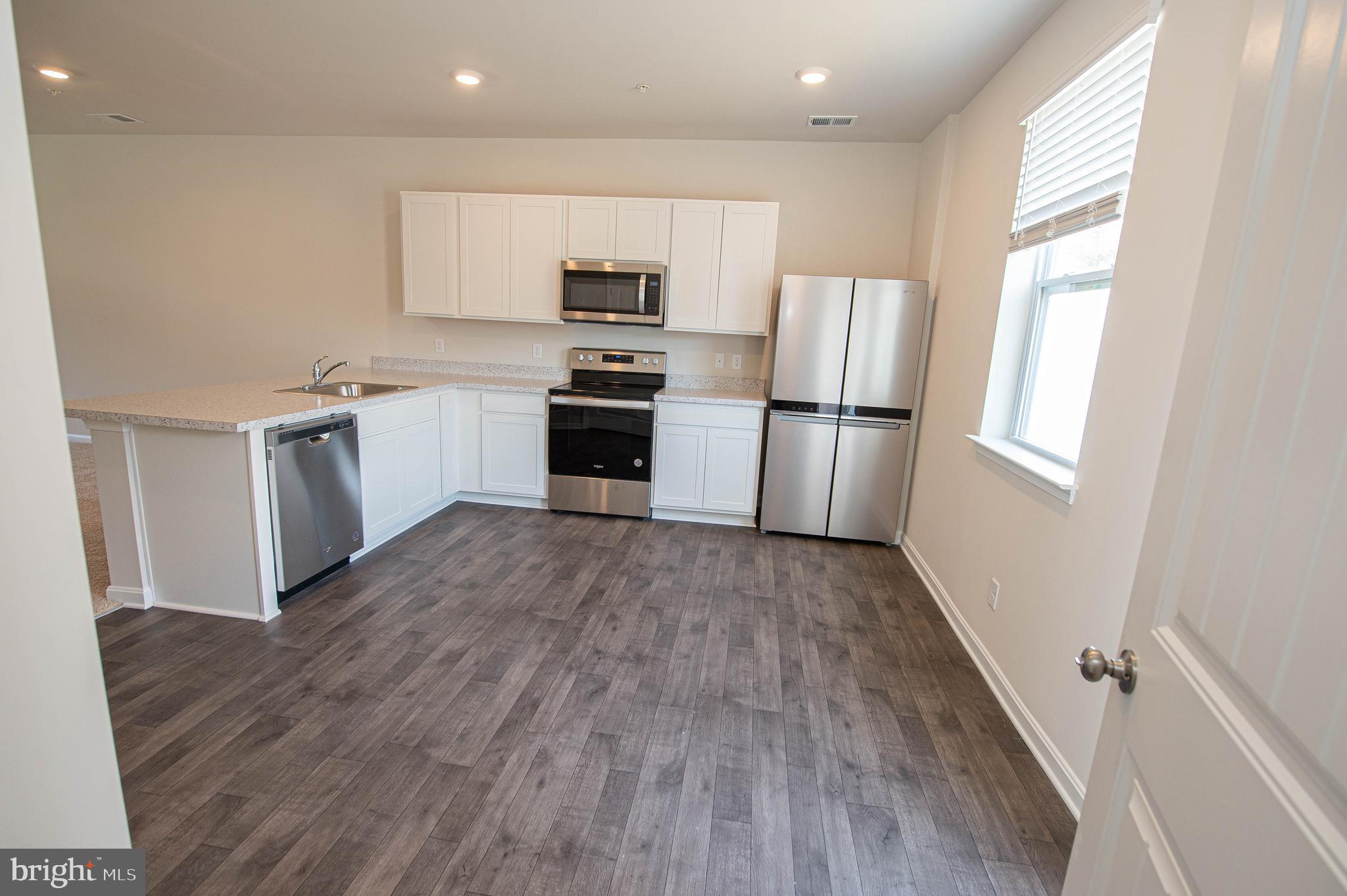 130 Willowtree Lane Fruitland, MD 21826 - Photo 32 of 74 a kitchen with a refrigerator and a stove top oven