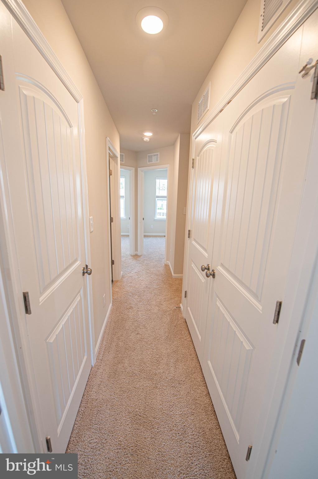 130 Willowtree Lane Fruitland, MD 21826 - Photo 42 of 74 a view of a hallway with white walls and stairs