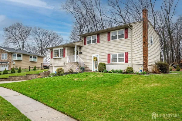 a front view of house with yard and green space