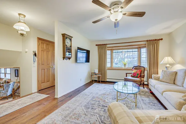 a living room with furniture a window and a chandelier