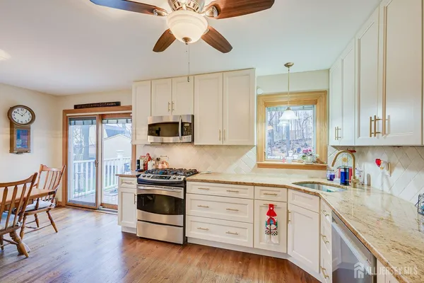 a kitchen with stainless steel appliances a stove a sink and a refrigerator