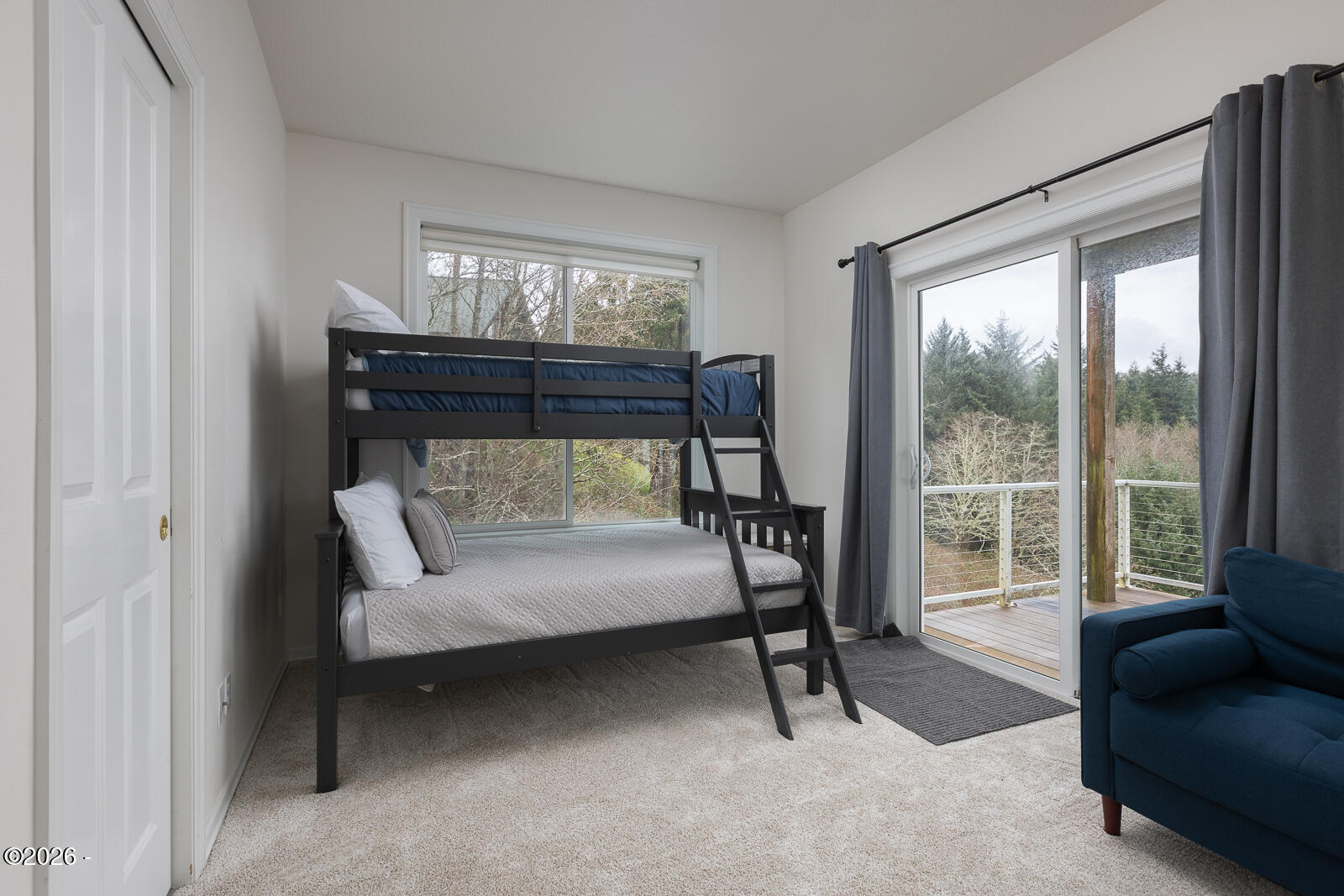 7415 East Summit Road Pacific City, OR 97135 - Photo 30 of 44 a bedroom with furniture and a large window