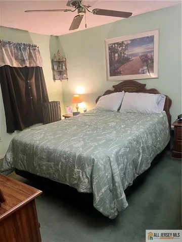 a bedroom with a bed and dresser