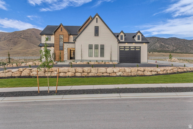2828 Jojo Road Eagle Mountain, UT 84005 - Photo 2 of 63 Modern farmhouse exterior with white brick and wood-panel accents