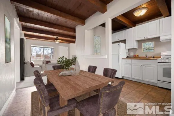 a view of a dining room with furniture and window