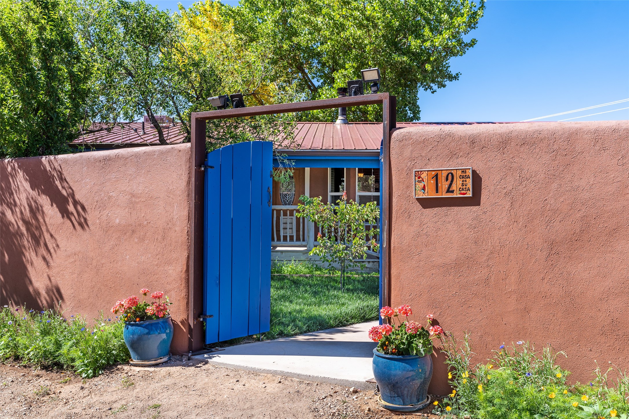 12 Apache Ridge Road Santa Fe, NM 87505 - Photo 3 of 69 entrance with a row of flowers