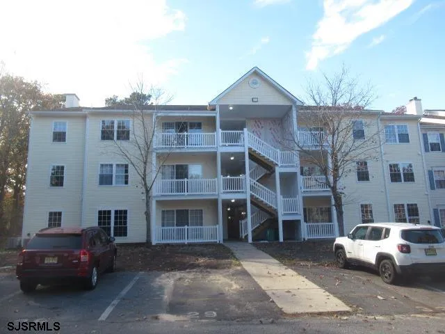 a front view of a residential apartment building with a yard