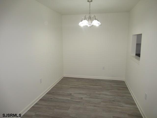 35 Apache Court, Unit 35 Galloway Township, NJ 08205 - Photo 5 of 10 a view of a room with wooden floor and chandelier